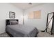 Neutral secondary bedroom with a gray bed set and a window with wood-look blinds at 5043 Naff Ridge Dr, Las Vegas, NV 89131