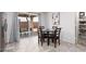 Bright dining area with a dark wood table and seating for four next to a sliding glass door at 5043 Naff Ridge Dr, Las Vegas, NV 89131