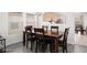 Spacious dining room with a large dark wood table and seating for six by large bright window at 5043 Naff Ridge Dr, Las Vegas, NV 89131