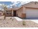 Single-story home featuring a concrete walkway, desert landscaping, and two-car garage at 5043 Naff Ridge Dr, Las Vegas, NV 89131