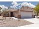 Inviting single story home featuring low-maintenance desert landscaping and attached two car garage at 5043 Naff Ridge Dr, Las Vegas, NV 89131