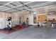 Spacious two car garage equipped with gym equipment and storage shelving at 5043 Naff Ridge Dr, Las Vegas, NV 89131