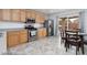 Open kitchen and dining area with stainless steel appliances and light wood cabinets at 5043 Naff Ridge Dr, Las Vegas, NV 89131