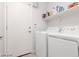 Well-lit laundry room with modern appliances and storage shelves at 5043 Naff Ridge Dr, Las Vegas, NV 89131