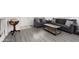 Comfortable living room with gray couches, wood-look floors, and a rustic coffee table at 5043 Naff Ridge Dr, Las Vegas, NV 89131