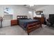 Main bedroom with warm wood furniture set and two large windows with window coverings at 5043 Naff Ridge Dr, Las Vegas, NV 89131