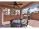 Covered patio with ceiling fan and outdoor dining set, perfect for gatherings at 5043 Naff Ridge Dr, Las Vegas, NV 89131