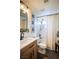 Neutral bathroom features patterned curtain, modern fixtures, and artwork at 520 Arrowhead Trl # 1322, Henderson, NV 89015