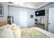 Bright bedroom featuring a TV, door and decorative items creating a cozy ambiance at 520 Arrowhead Trl # 1322, Henderson, NV 89015