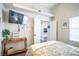 Inviting bedroom with a TV, console table, and view into another room through open doors at 520 Arrowhead Trl # 1322, Henderson, NV 89015