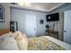 Bright bedroom featuring a TV, door and decorative items creating a cozy ambiance at 520 Arrowhead Trl # 1322, Henderson, NV 89015