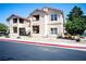 A two-story condo building with red tile roofing and well-maintained landscaping at 520 Arrowhead Trl # 1322, Henderson, NV 89015