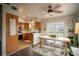 A cozy kitchen and dining area with wood cabinets and a dining table with modern chairs at 520 Arrowhead Trl # 1322, Henderson, NV 89015