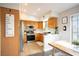 Bright kitchen with wood cabinets, stainless steel appliances, a breakfast bar and dining area at 520 Arrowhead Trl # 1322, Henderson, NV 89015
