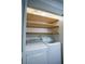 Functional laundry closet with washer, dryer, and shelving at 520 Arrowhead Trl # 1322, Henderson, NV 89015