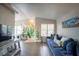 Spacious living room with hardwood floors, bright mural, and comfortable blue couch at 520 Arrowhead Trl # 1322, Henderson, NV 89015