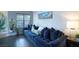 Cozy living room with a plush blue sectional sofa, lots of pillows and a wall art at 520 Arrowhead Trl # 1322, Henderson, NV 89015