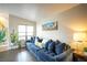 Comfortable living room with a spacious blue sectional sofa and a scenic view wall art at 520 Arrowhead Trl # 1322, Henderson, NV 89015