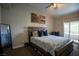 Tranquil main bedroom featuring a cozy bed, warm lighting, and access to a private balcony at 520 Arrowhead Trl # 1322, Henderson, NV 89015