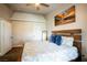 Bright main bedroom with tray ceiling, accent wall art, and a door leading to the bathroom at 520 Arrowhead Trl # 1322, Henderson, NV 89015