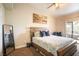 Tranquil main bedroom featuring a cozy bed, warm lighting, and access to a private balcony at 520 Arrowhead Trl # 1322, Henderson, NV 89015