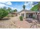 Cozy backyard featuring a brick patio, desert landscaping and mature trees providing shade at 542 Grimsby Ave, Henderson, NV 89014