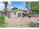 Picture of the backyard that has desert landscaping, a brick patio, and sliding glass doors at 542 Grimsby Ave, Henderson, NV 89014