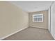 Bright bedroom featuring neutral walls, carpet flooring, and a large window at 542 Grimsby Ave, Henderson, NV 89014