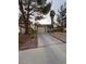 Inviting single-story house with a paved driveway, desert landscaping, and a simple, clean facade at 542 Grimsby Ave, Henderson, NV 89014