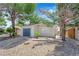 Cozy single-story home showcasing neutral paint, gravel landscaping, mature trees, and a two-car garage at 542 Grimsby Ave, Henderson, NV 89014