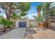 Charming single-story home featuring desert landscaping, mature trees, and a two-car garage at 542 Grimsby Ave, Henderson, NV 89014