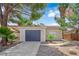 Inviting single-story home with desert landscaping and a blue two-car garage door at 542 Grimsby Ave, Henderson, NV 89014