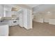 Open kitchen featuring white cabinets, modern appliances, tile flooring, and ample storage at 542 Grimsby Ave, Henderson, NV 89014