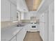 Bright kitchen features white cabinets, appliances and speckled countertops at 542 Grimsby Ave, Henderson, NV 89014