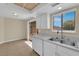 Bright kitchen features white cabinets, appliances and speckled countertops with dining area at 542 Grimsby Ave, Henderson, NV 89014