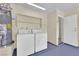 Bright laundry area featuring a washer, dryer, and water heater at 542 Grimsby Ave, Henderson, NV 89014