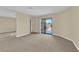 Spacious living room with carpet and sliding glass door access to the backyard at 542 Grimsby Ave, Henderson, NV 89014