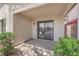 Covered patio with a sliding glass door and desert landscaping and green bushes at 542 Grimsby Ave, Henderson, NV 89014