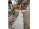 Gated side yard featuring low-maintenance landscaping and a concrete walkway at 542 Grimsby Ave, Henderson, NV 89014