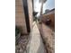 Narrow side yard with a concrete path and minimal landscaping; small grill and fencing visible at 542 Grimsby Ave, Henderson, NV 89014