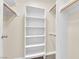 Spacious walk-in closet features custom shelves and ample storage space with wood rod at 542 Grimsby Ave, Henderson, NV 89014