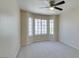 Neutral bedroom with new carpet, a ceiling fan and bright bay windows at 5424 Comchec Way # 105, Las Vegas, NV 89108