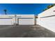 White garages with driveway offer secure parking and storage solutions at 5424 Comchec Way # 105, Las Vegas, NV 89108
