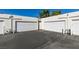 Row of white garages with driveway, providing ample parking and storage at 5424 Comchec Way # 105, Las Vegas, NV 89108