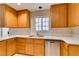 Well-maintained kitchen featuring wooden cabinets, countertops, stainless steel dishwasher, and a window at 5424 Comchec Way # 105, Las Vegas, NV 89108