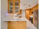Bright kitchen featuring wooden cabinets, stainless steel appliances, and breakfast bar at 5424 Comchec Way # 105, Las Vegas, NV 89108