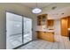 Cozy kitchen view with breakfast bar and sliding glass door to patio at 5424 Comchec Way # 105, Las Vegas, NV 89108