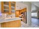 Modern kitchen with stainless steel appliances, wooden cabinets, breakfast bar, and easy access to dining and living areas at 5424 Comchec Way # 105, Las Vegas, NV 89108