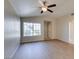 Bright living room with hardwood floors, a ceiling fan, and large windows that provide plenty of natural light at 5424 Comchec Way # 105, Las Vegas, NV 89108