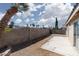 An empty backyard with a block fence and small patio awaits your personal touch and landscaping ideas at 5528 Morningcross St, Las Vegas, NV 89130